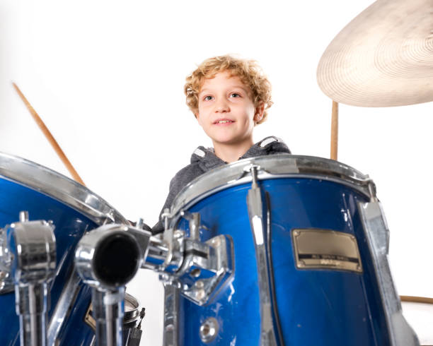 istock young blond caucasian boy at drumset in studio 891996656