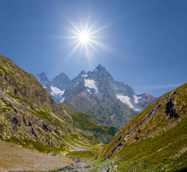 istock beautiful green mountains under a sparkle sun 891997472