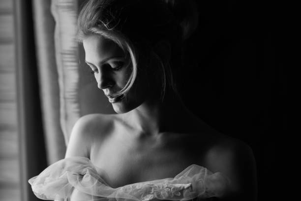 istock Woman standing in front of the window 891997484