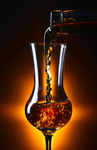 istock Pouring alcohol drink into a wineglass . 892002974