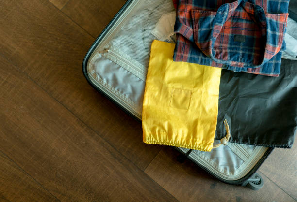 istock arranging clothes in suitcase for travel 892005548