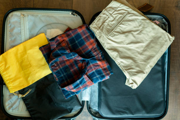 istock arranging clothes in suitcase for travel 892005652