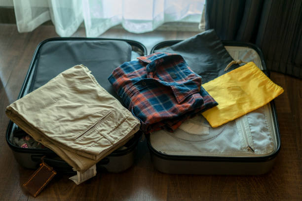 istock arranging clothes in suitcase for travel 892005672