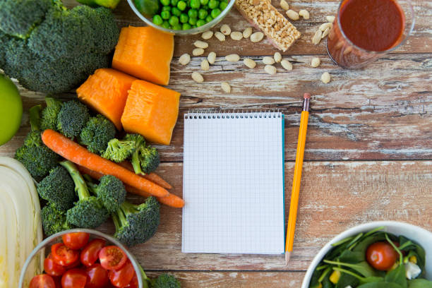 istock close up of ripe vegetables and notebook on table 892006456