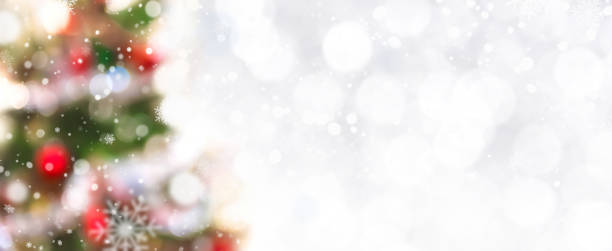 istock Abstract white bokeh with snow and blurred decorated Christmas tree at border 892026090