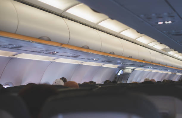 istock Interior inside of the plane with passengers. 892028924