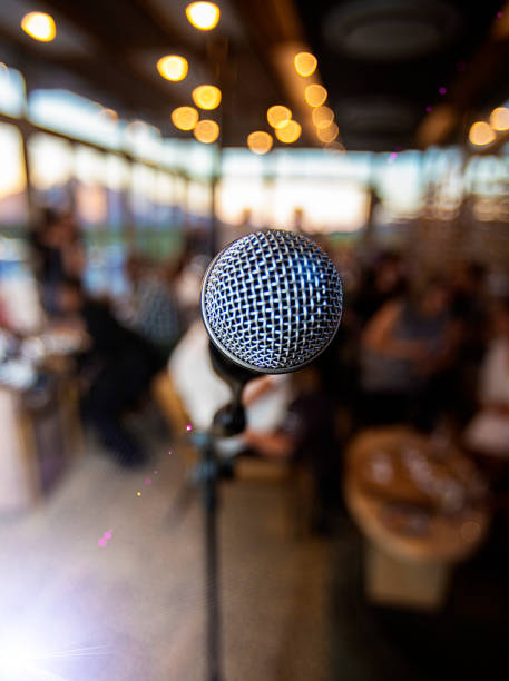 istock Microphone infront of out of focus  people waiting 892035184