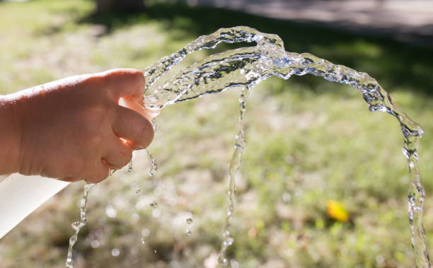 istock water from the hose outdoors 892036172