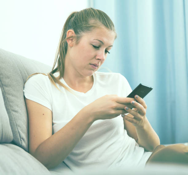 istock Girl is bored and chatting phone 892039652