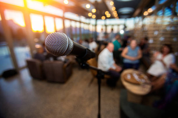 Microphone infront of an out of focus audience stock photo