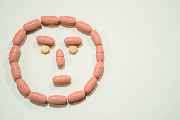 istock Pills. Tablets lined in the form of a face 892043214