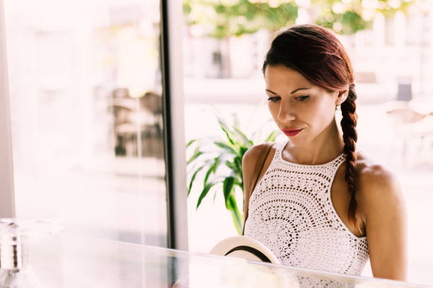 istock Woman standing in shop ordering. 892046094