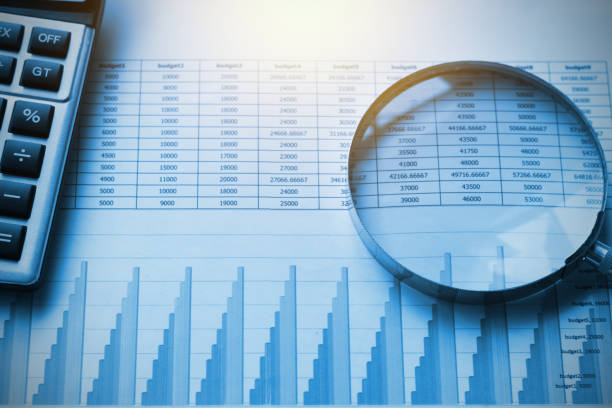 istock business documents accounting with calculator and magnifying glass. concept for financial 892046664