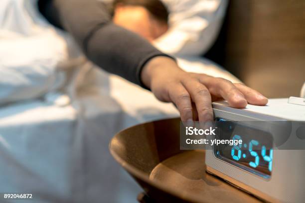 Alarm Clock At Bedside Stock Photo - Download Image Now - Alarm Clock, Hand, Waking up
