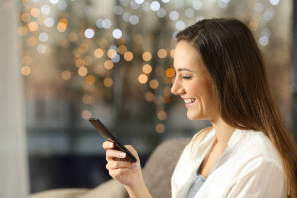 istock Woman using a smart phone at home in the evening 892049340