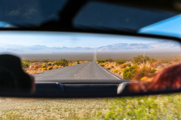 Rear mirror view on desert landscape, Nevada