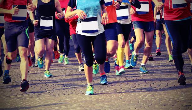 istock one woman and many men runs during race with vintage effect 892065560