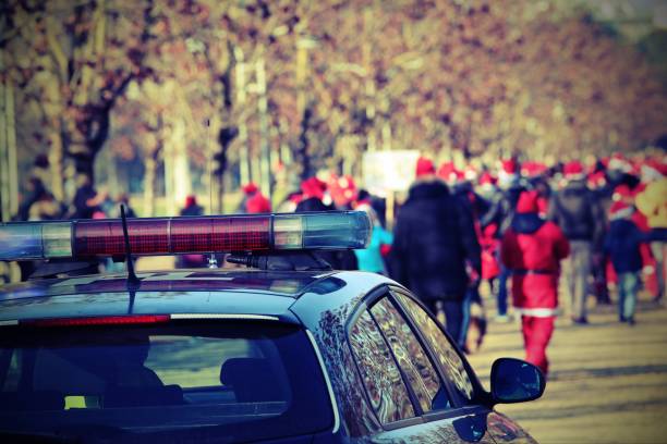 istock police car and many people with red hat with vintage effect 892069454