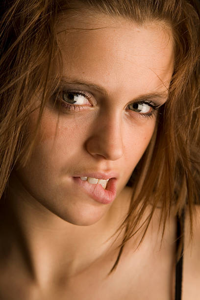 istock young sexy female head shot biting her lip 89207400