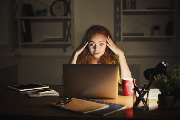 istock Freelancer working on laptop at home until late evening 892082932