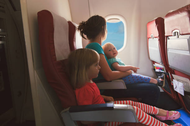 istock mother with two kids travel by plane 892083684