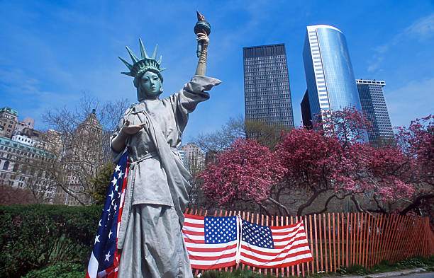 istock Human statue of Liberty with american flag 89208518