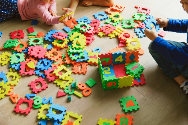 istock kids playing with puzzle, education concept 892088942