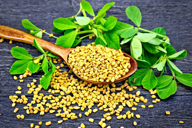 istock Fenugreek with leaf in spoon on black board 892089070