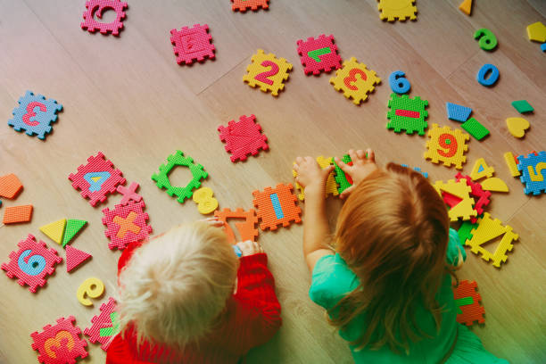istock kids playing with puzzle, education concept 892089338
