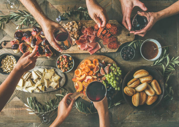 istock Top view of people drinking and eating together over table 892089380
