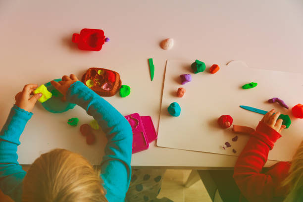 istock kids play with clay molding shapes 892091694