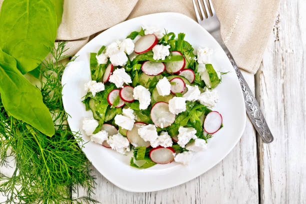 istock Salad with spinach and radish in plate on board top 892092054
