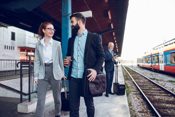 istock Business people with luggage at train station. 892092124