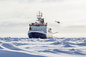 Research icebreaker and helicopter