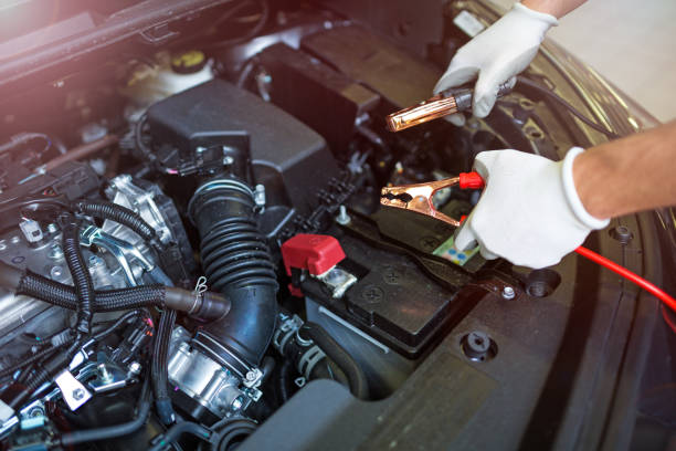 istock Mechanic using jumper cables to start a car 892095704