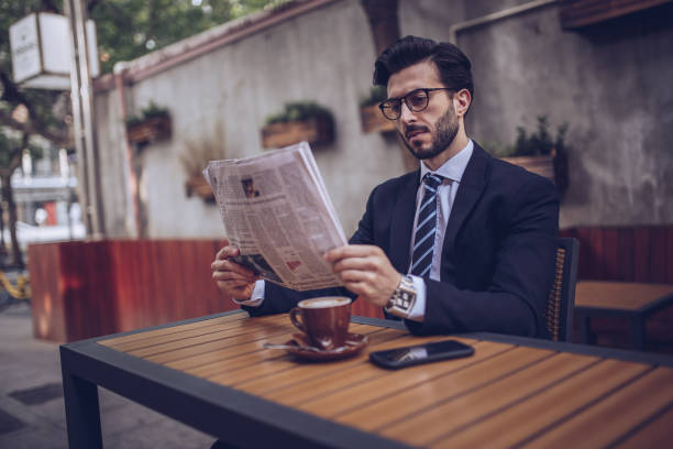 istock Reading the news in cafe 892100338