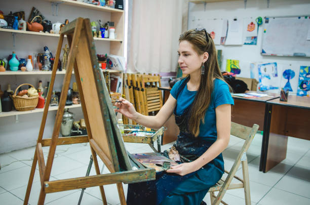 istock Redhead girl in art studio 892100376