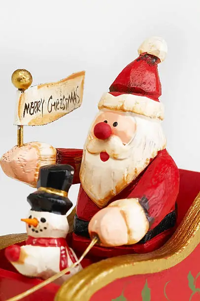 Photo of Santa Claus and snowman on sleigh