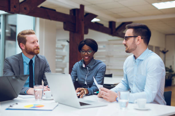 istock Business people cooperating and exchanging ideas during formal meeting 892105144