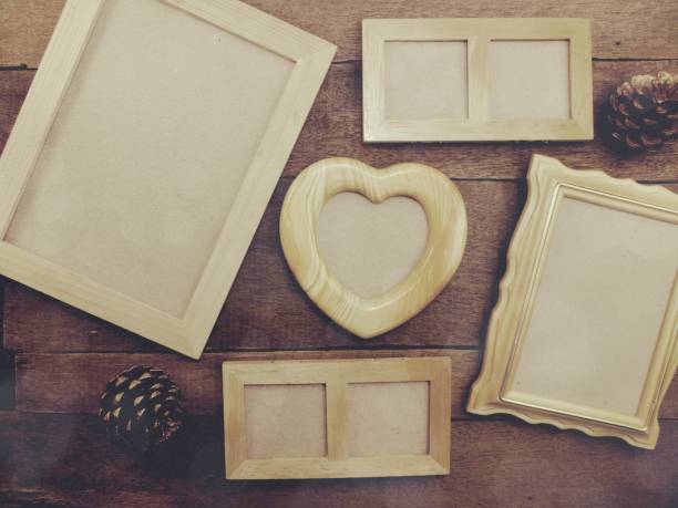 istock blank photo frames on the table wooden background 892105188