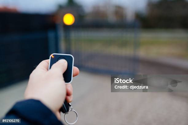 Man Opening Automatic Property Gate Stock Photo - Download Image Now - Gate, Automatic, Automated