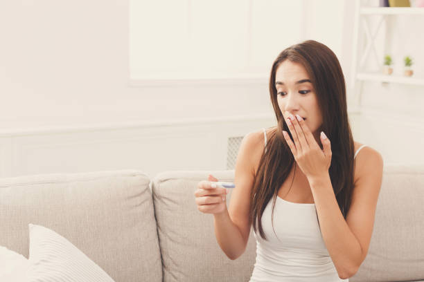 istock Surprised girl with recent pregnancy test 892105568