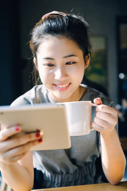 istock Asian girl using digital tablet at cafe,Shanghai,China 892114410