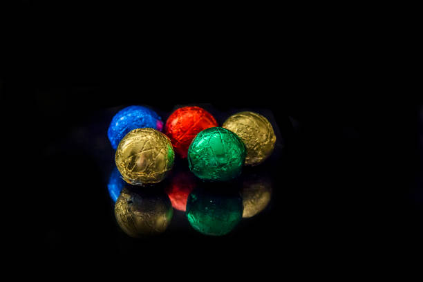 Different color balls irregularly shaped on white background with copy space, 3d render.
