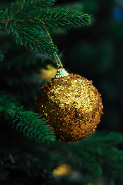 istock closeup golden ball on a branch of a tree 892117754