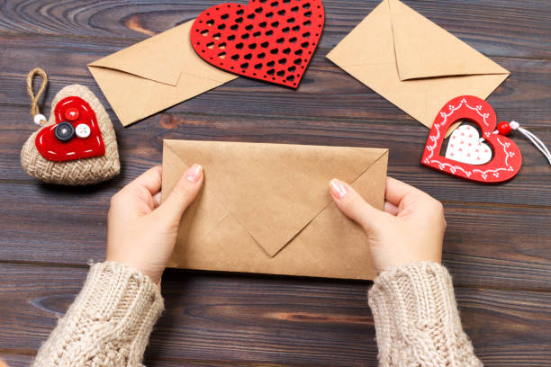 istock Woman preparing handmade envelope for wrapping on Valentine's Day. Valentine day concept with copyspace 892126142