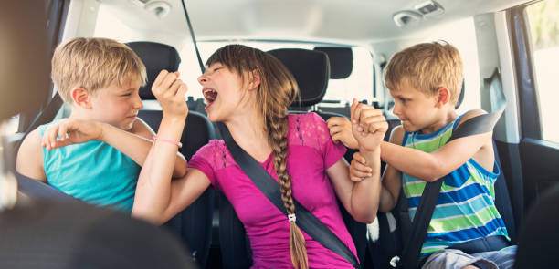 istock Three naughty kids fighting in a car 892126166