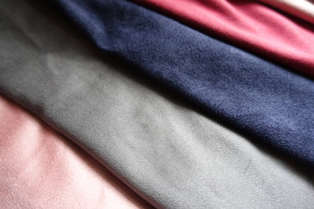 istock Closeup of artificial suede in red, pink, blue, grey 892126622