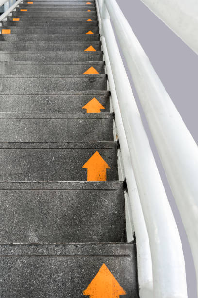 istock Yellow arrow on public concrete ladders for walking direction 892135450