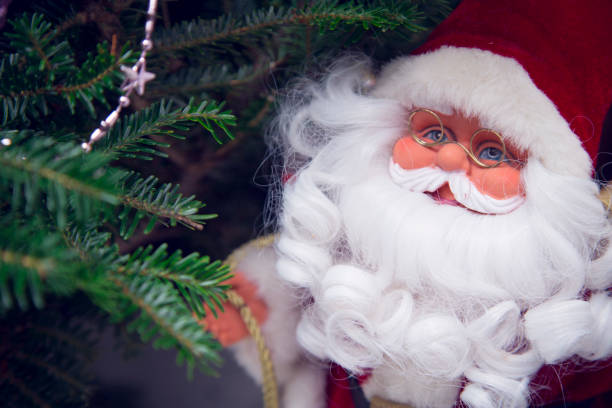 istock A toy Santa Claus and a Christmas tree 892141966